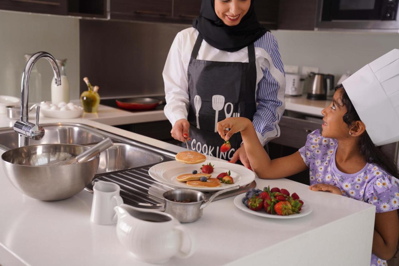 Majestic Arjaan By Rotana - Manama Aparthotel Exterior foto A woman cooking with her daughter